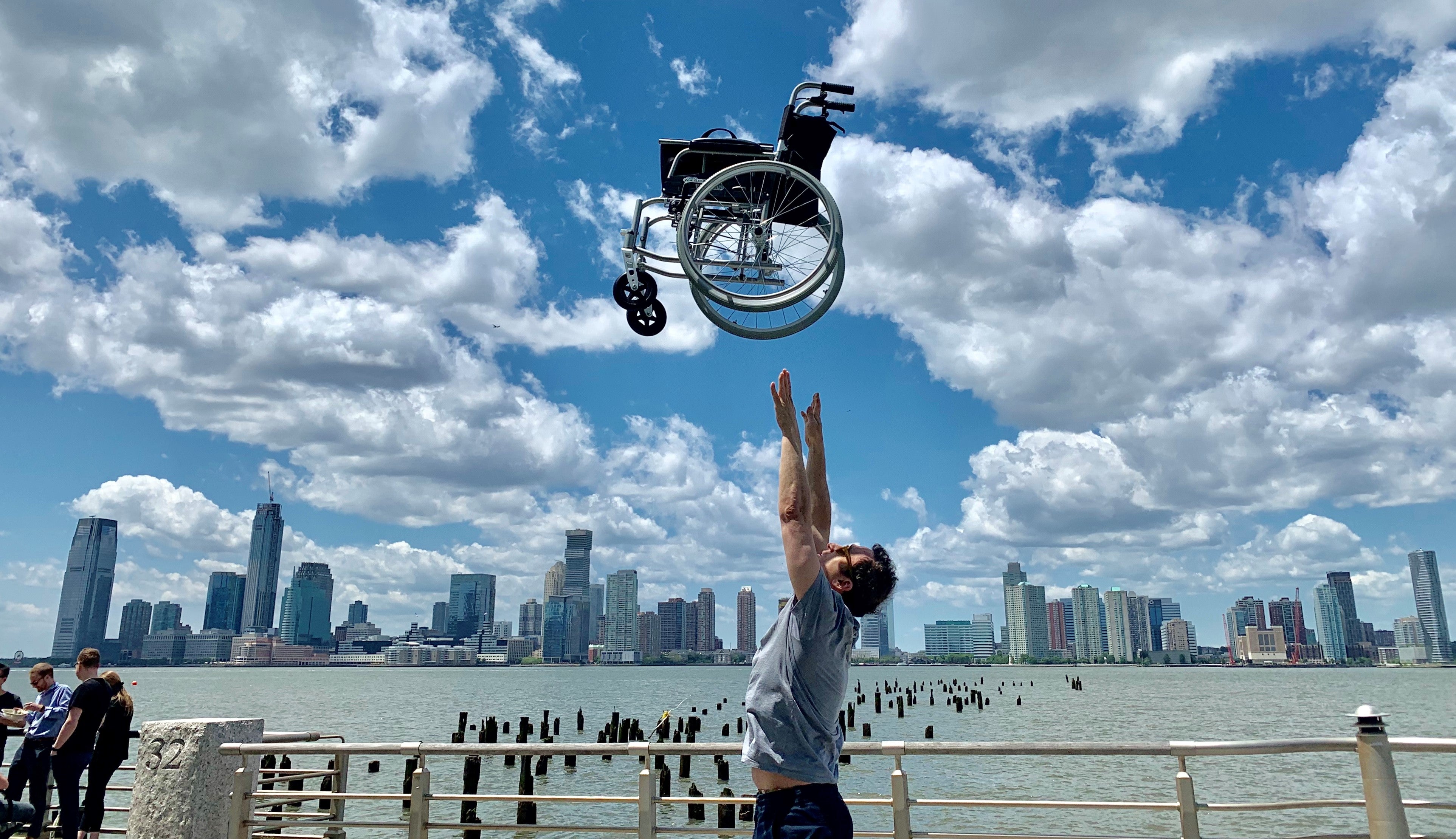 Man tossing lightest wheelchair in the world above head